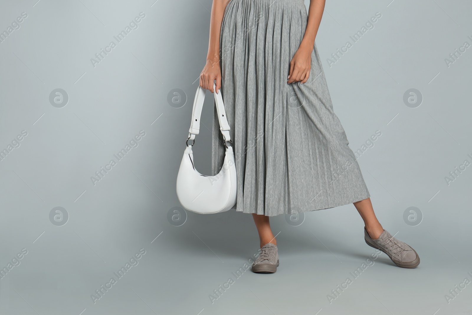 Photo of Woman with stylish bag on grey background, closeup