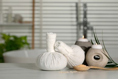 Photo of Composition with spa products and burning candles on white table indoors, space for text