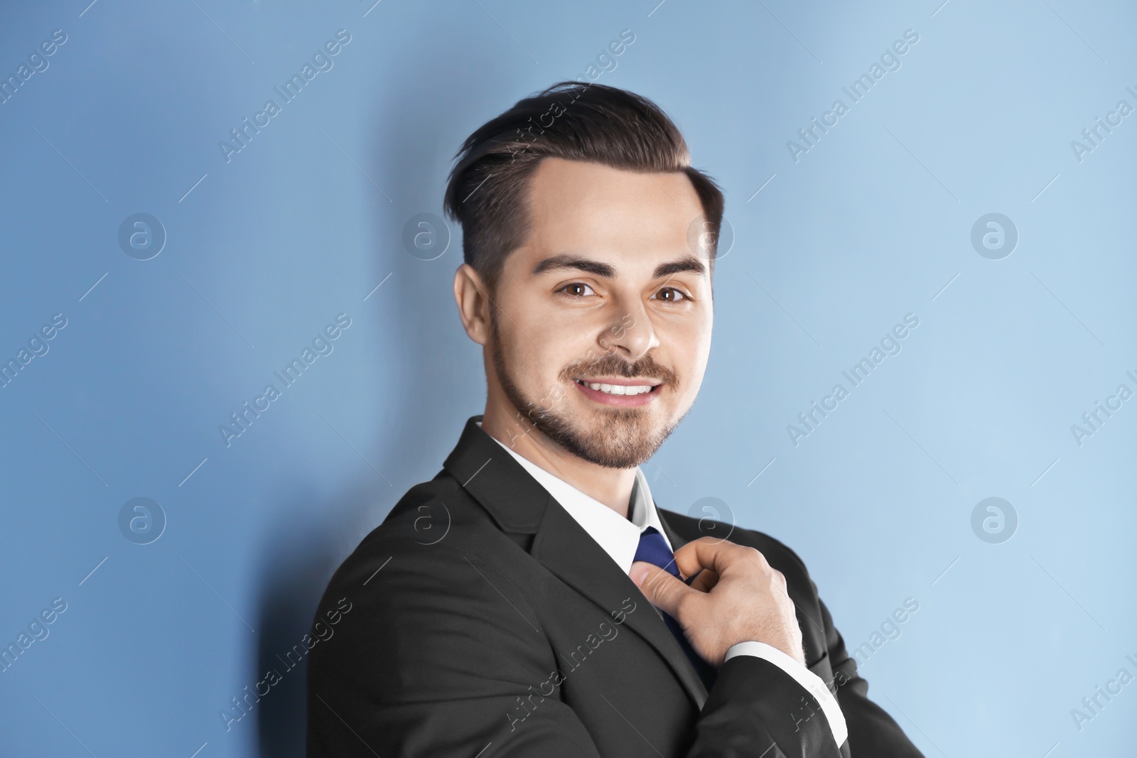 Photo of Portrait of young man with beautiful hair on color background