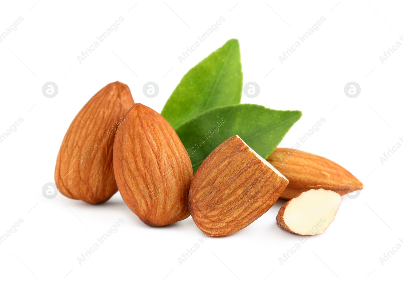 Photo of Organic almond nuts and green leaves on white background. Healthy snack