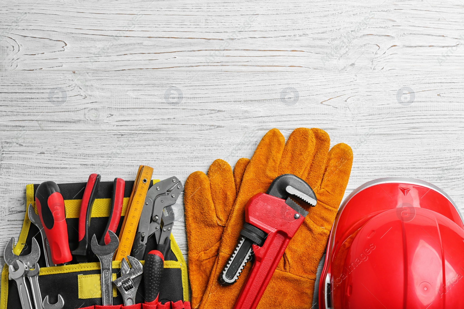 Photo of Flat lay composition with different construction tools and space for text on white wooden background