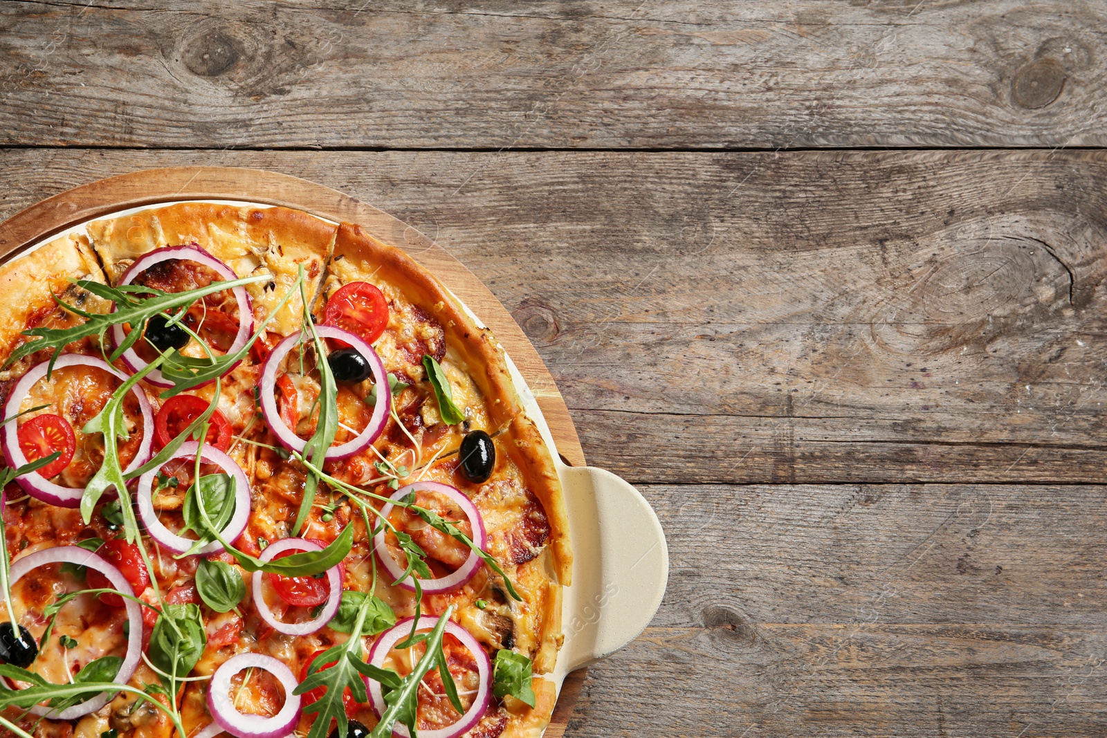 Photo of Tasty homemade pizza and space for text on wooden table, top view