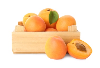 Wooden crate of delicious ripe sweet apricots isolated on white