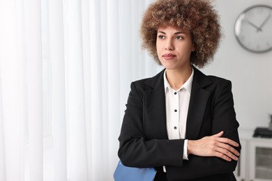 Photo of Beautiful female notary with clipboard in office, space for text
