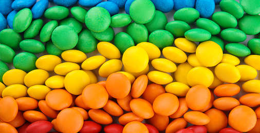 Many colorful candies as background, top view. Banner design 