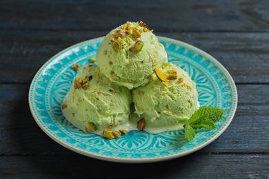 Delicious green ice cream served on wooden table