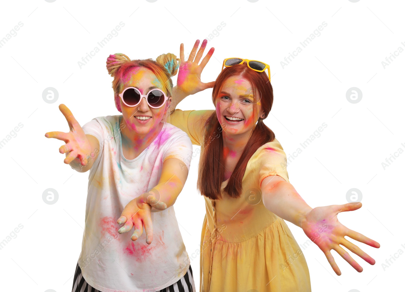 Photo of Women covered with colorful powder dyes on white background. Holi festival celebration