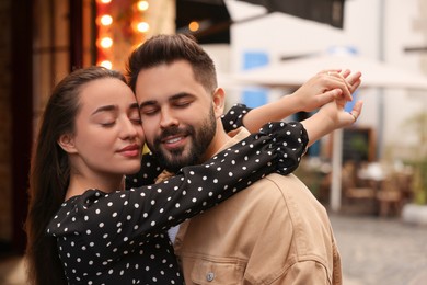 Lovely couple dancing together on city street