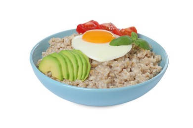 Photo of Delicious boiled oatmeal with fried egg, avocado and tomato in bowl isolated on white
