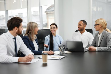 Photo of Lawyers working together at table in office