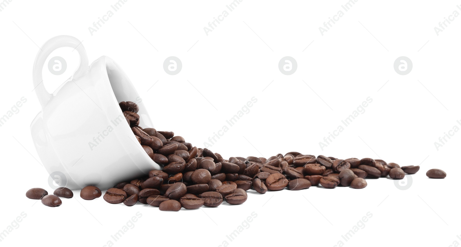 Photo of Coffee beans and overturned cup isolated on white