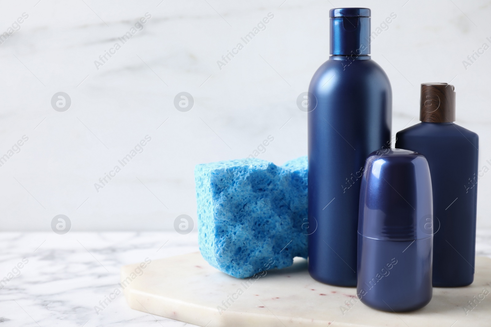 Photo of Set of different men's cosmetic products on white marble table. Space for text