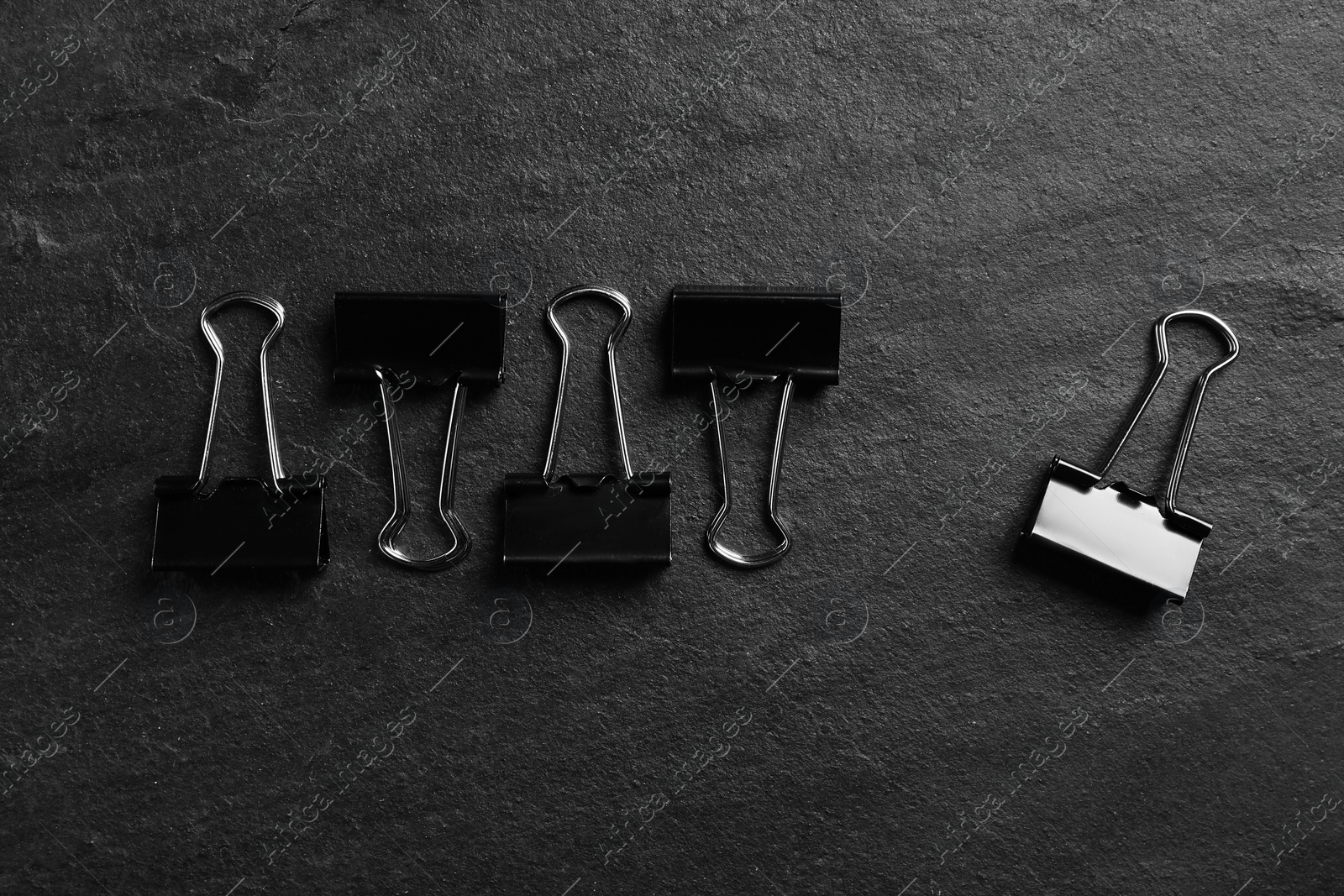 Photo of Flat lay composition with paper clips on black slate background. Pareto principle concept