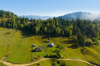 Image of Aerial view of beautiful landscape with forest and village in mountains