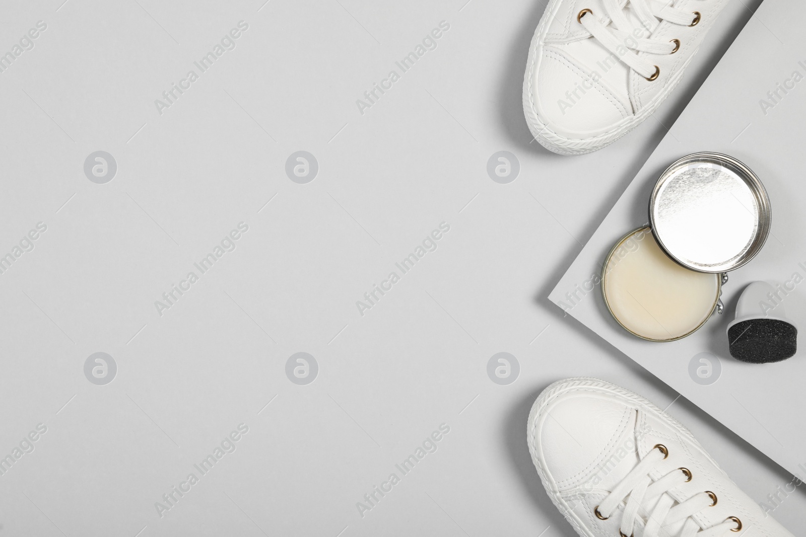 Photo of Stylish footwear and shoe care accessories on light grey background, flat lay. Space for text