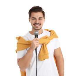 Young handsome man in casual clothes posing with microphone on white background