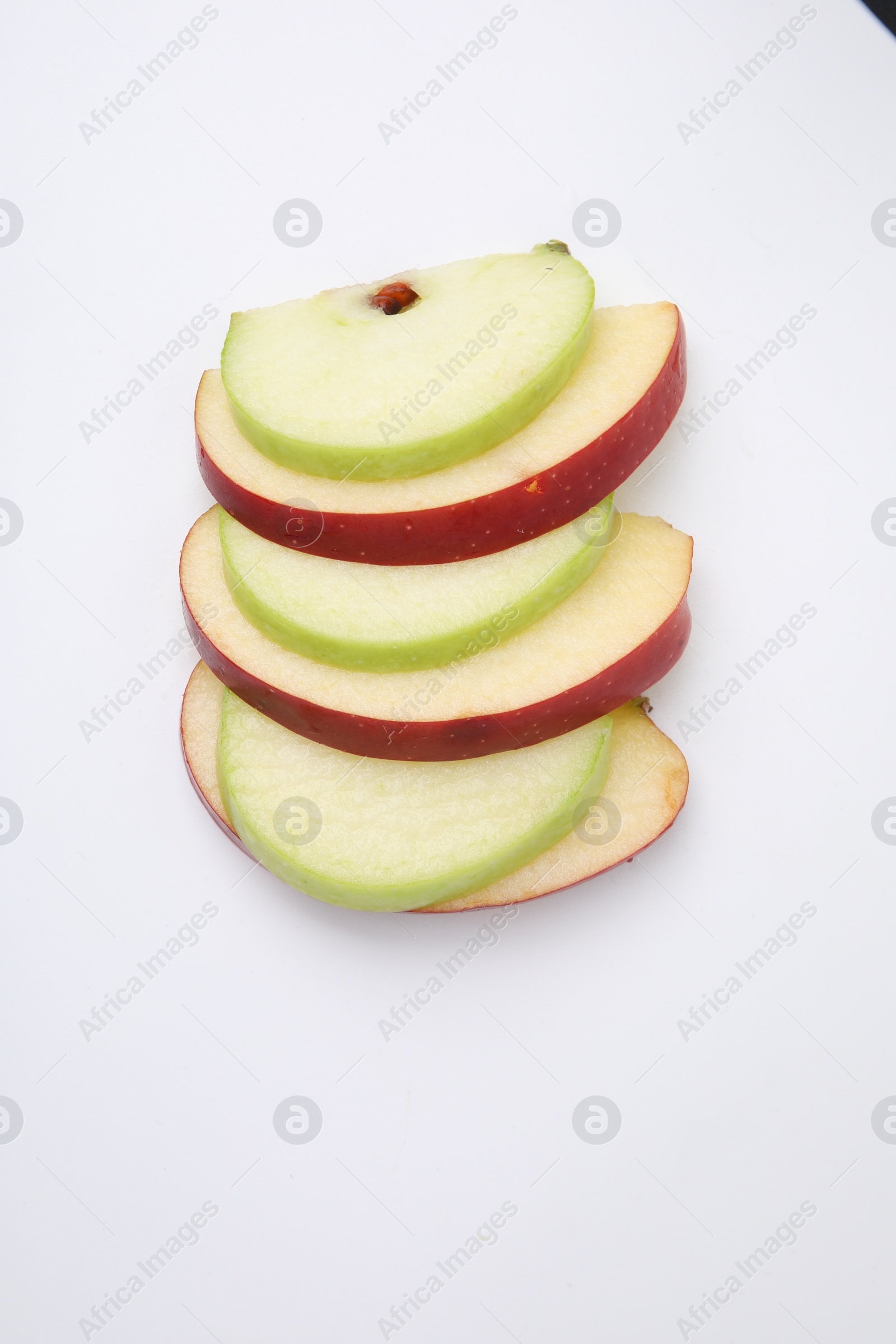 Photo of Slices of ripe apples isolated on white, top view