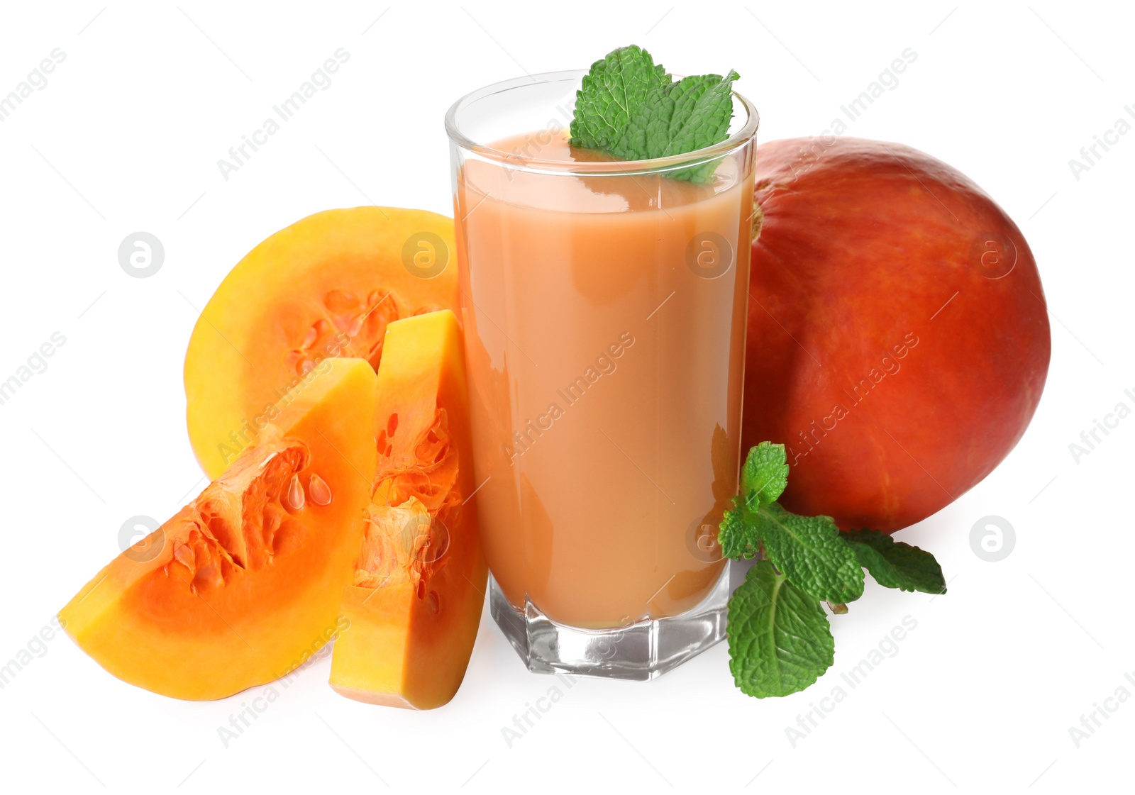 Photo of Glass of pumpkin juice and fresh vegetables with mint leaves on white background
