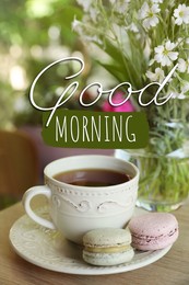 Image of Good morning! Cup of tea, macarons and flowers on table outdoors in morning