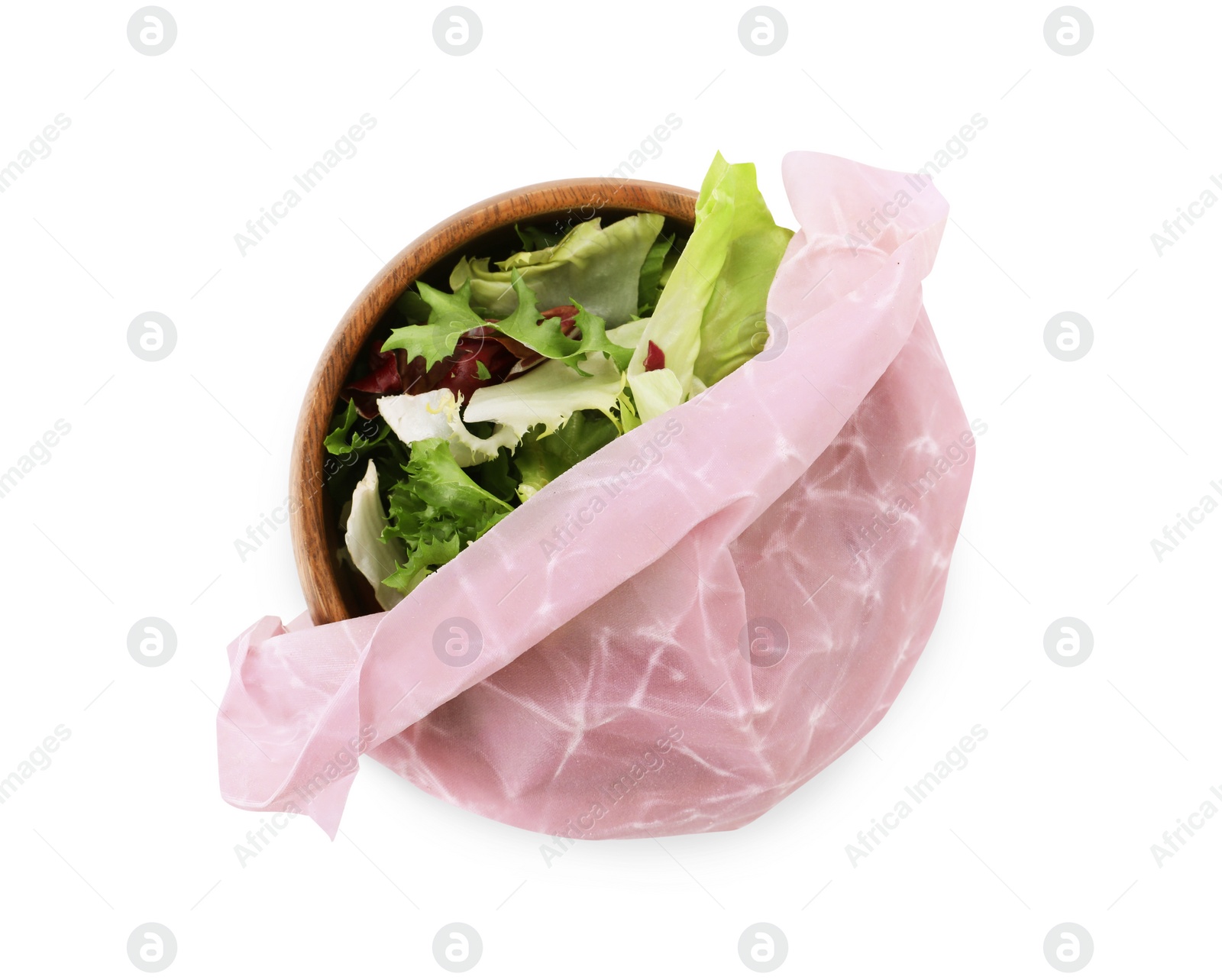 Photo of Wooden bowl of tasty salad covered with beeswax food wrap isolated on white, top view