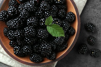 Bowl with fresh ripe blackberries on dark grey table, flat lay