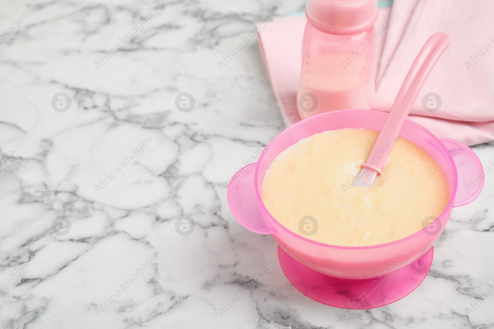 Photo of Healthy baby food served on white marble table. Space for text