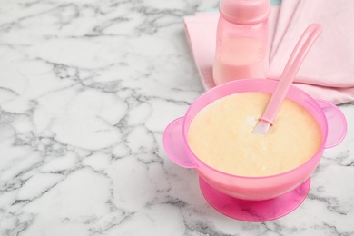 Photo of Healthy baby food served on white marble table. Space for text