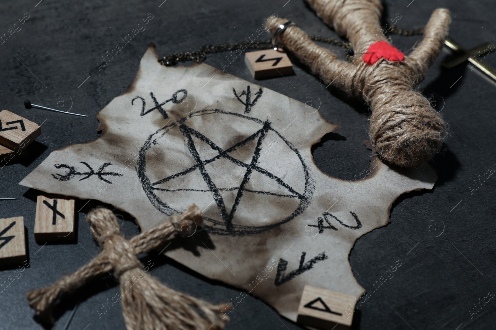 Photo of Voodoo dolls and ceremonial items on grey table