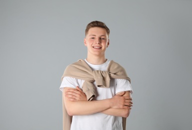 Photo of Portrait of teenage boy on light grey background