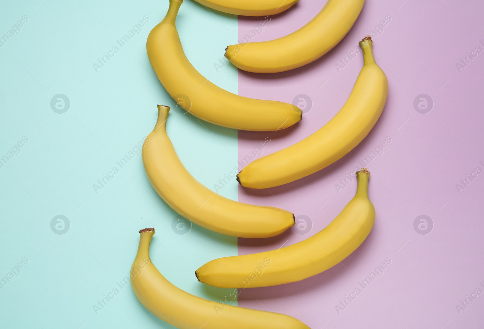 Photo of Ripe yellow bananas on color background, flat lay