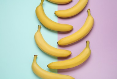 Ripe yellow bananas on color background, flat lay