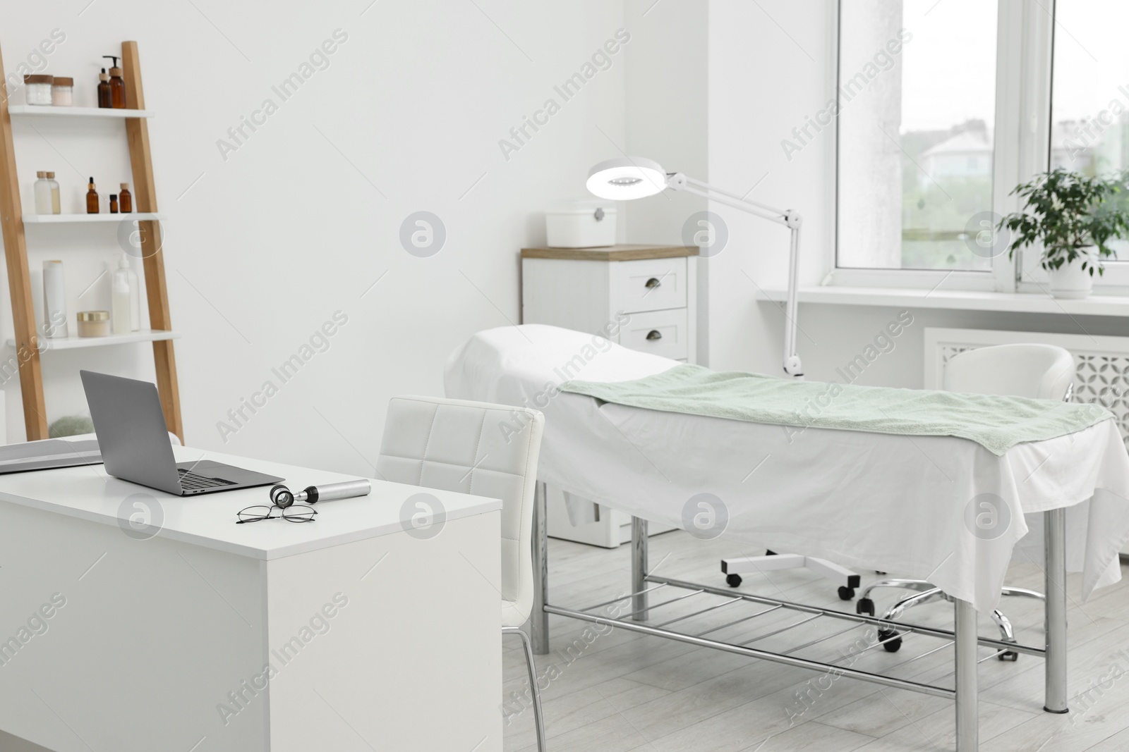 Photo of Modern interior of dermatologist's office with examination table