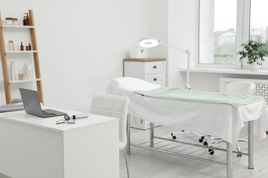 Modern interior of dermatologist's office with examination table