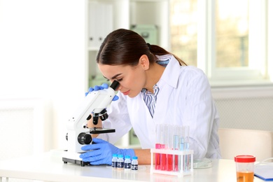 Female scientist working at table in laboratory. Research and analysis