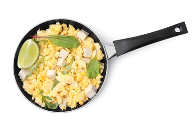 Photo of Frying pan with delicious scrambled eggs, tofu and lime isolated on white, top view