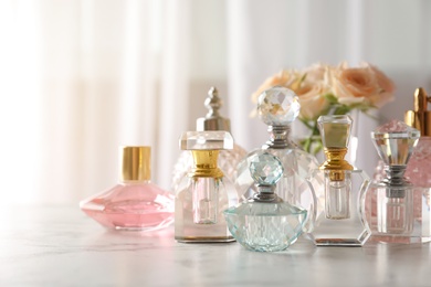 Photo of Many different perfume bottles on dressing table, space for text