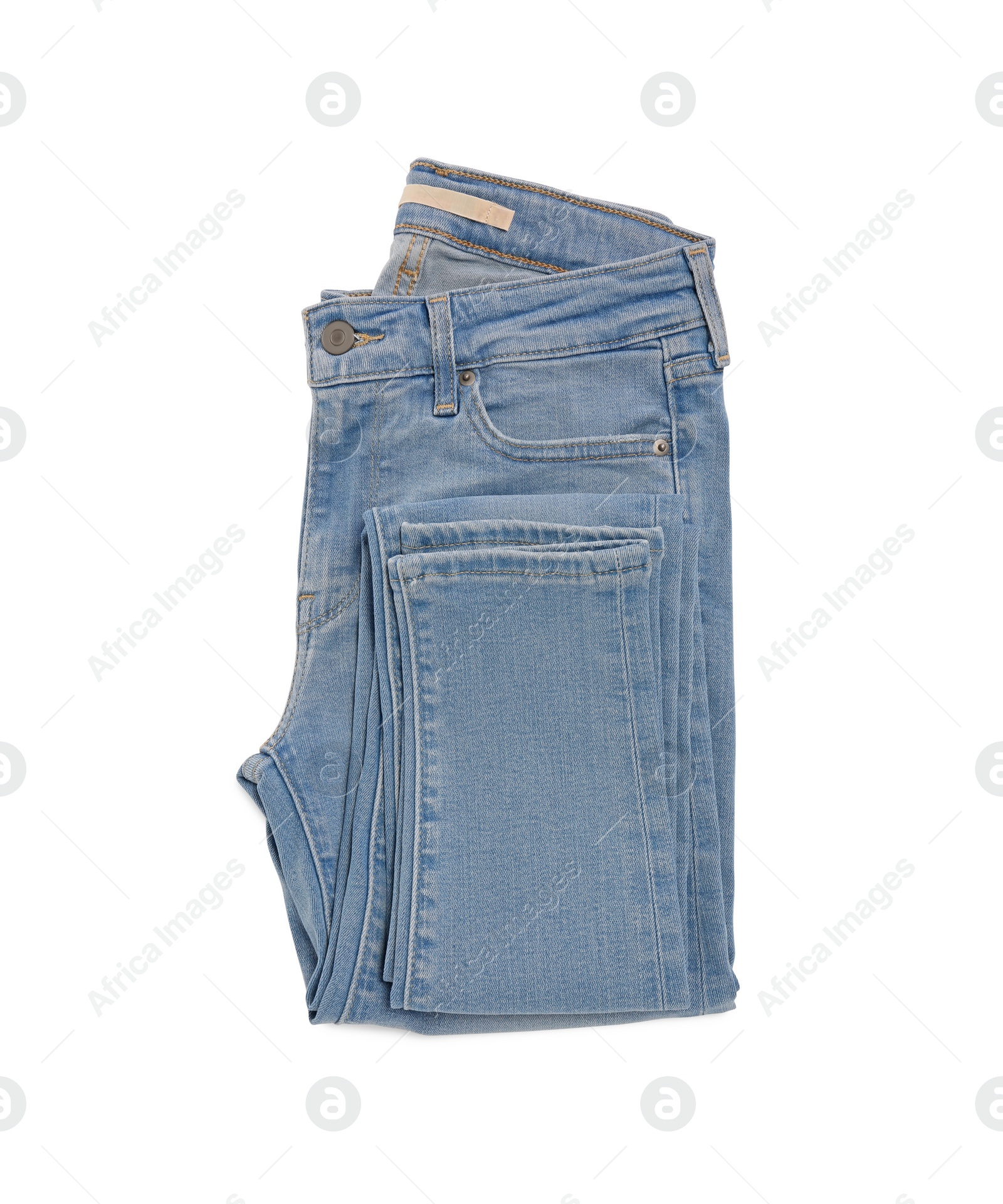 Photo of Folded light blue jeans isolated on white, top view