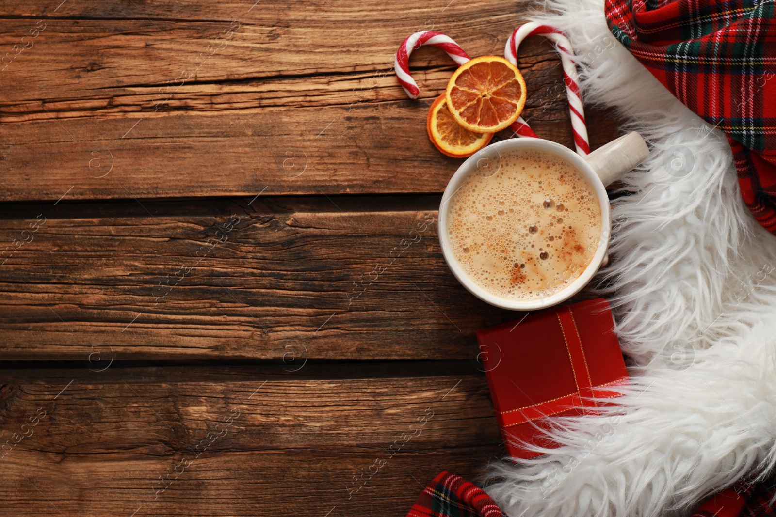 Photo of Flat lay composition with cup of coffee and sweets on wooden table, space for text. Cozy winter