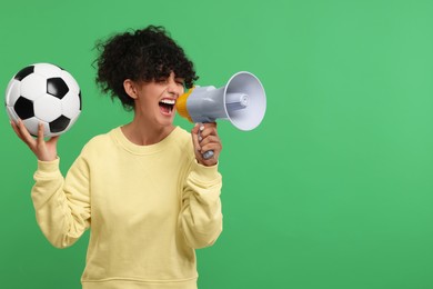 Fan with soccer ball using megaphone on green background, space for text