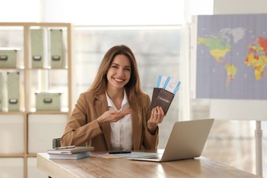 Travel agent with tickets and passports in office