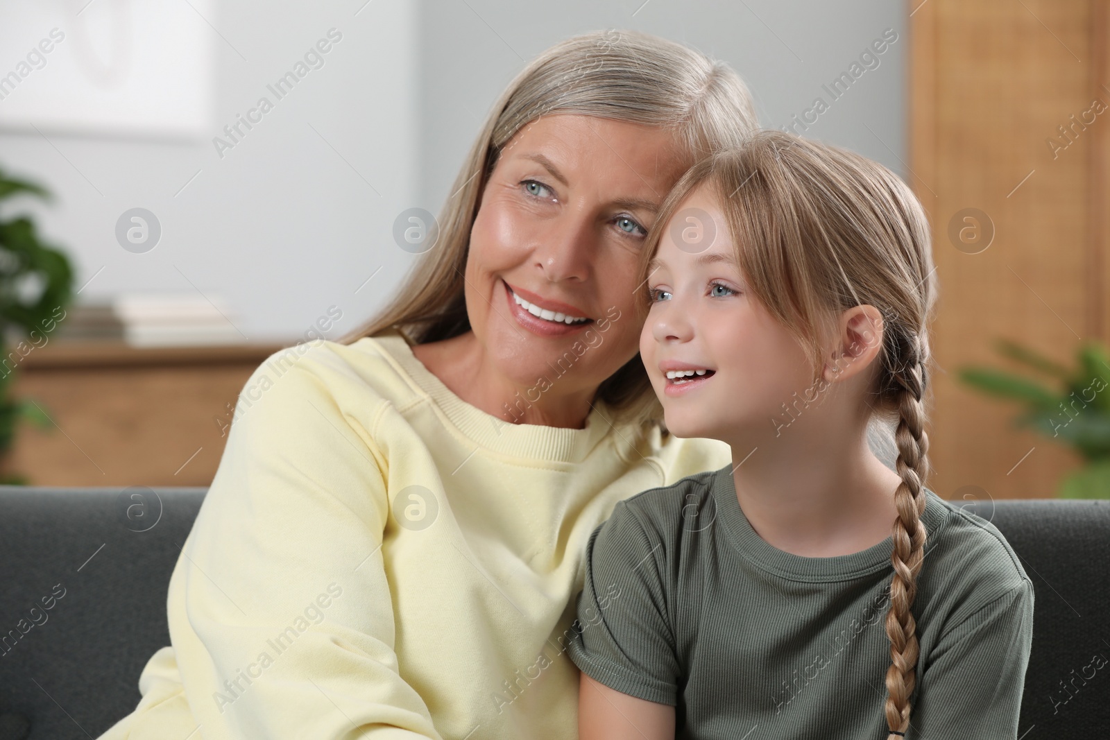 Photo of Happy grandmother with her granddaughter at home