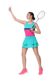 Young woman playing badminton with racket on white background