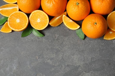 Flat lay composition with fresh oranges on grey background. Space for text