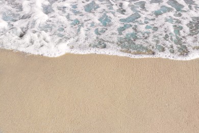 Photo of Beautiful foamy sea tide on sandy beach