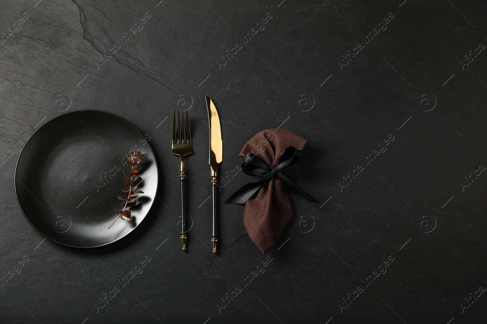 Photo of Stylish setting with elegant cutlery on grey textured table, flat lay. Space for text