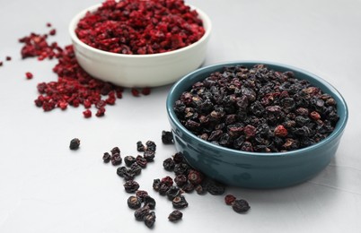 Dried black and red currant berries on light table