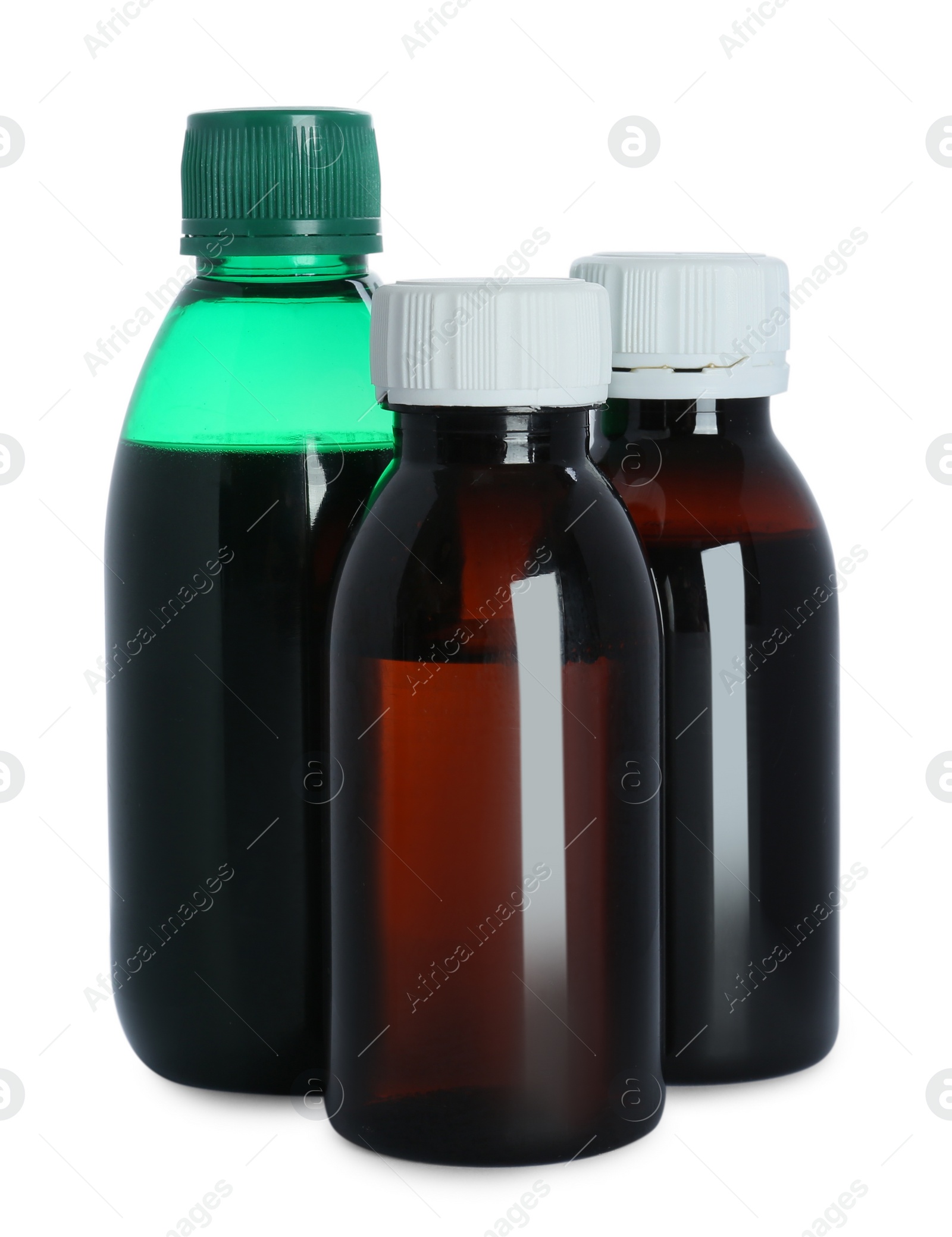 Photo of Bottles of cough syrup on white background