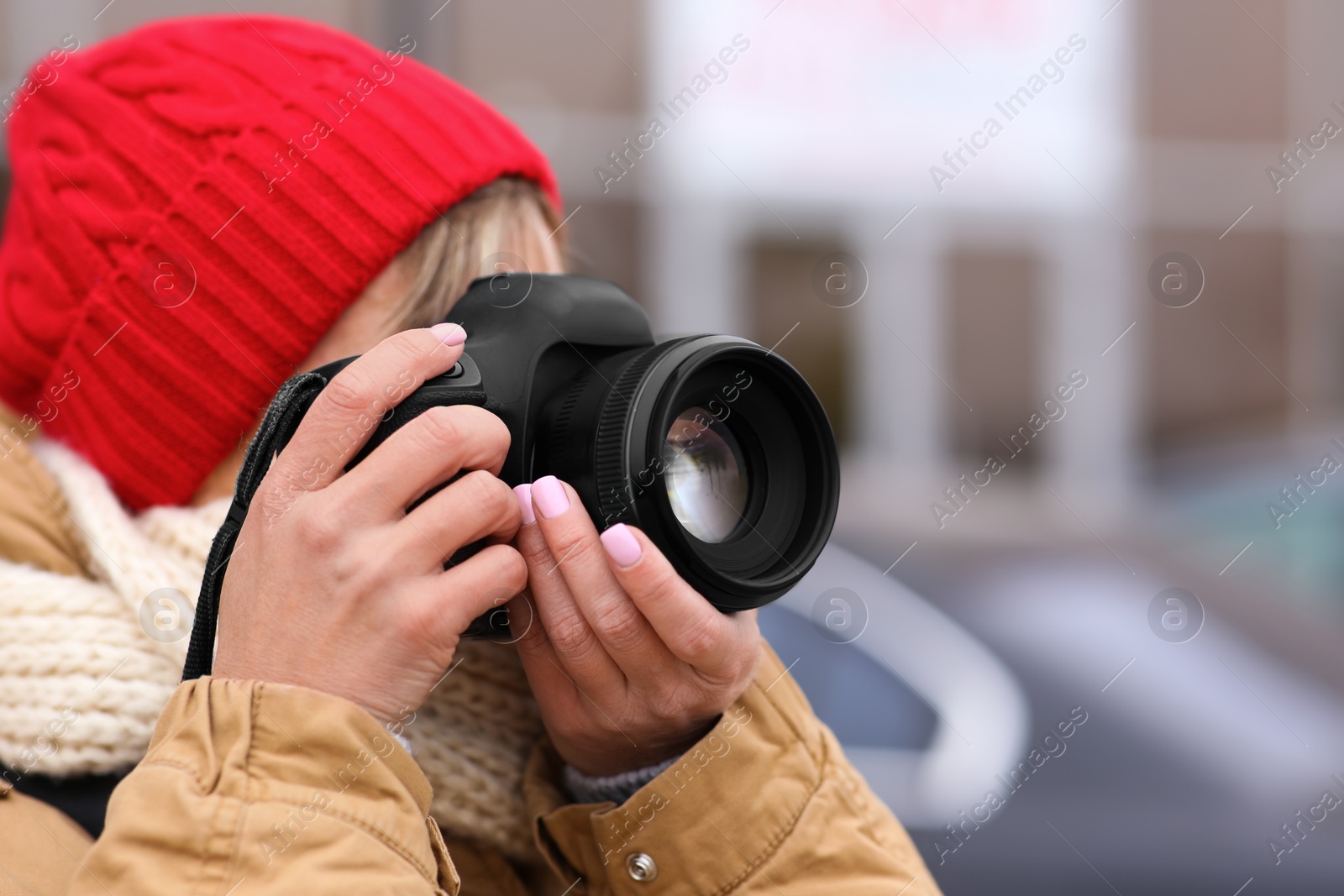 Photo of Photographer taking photo with professional camera outdoors