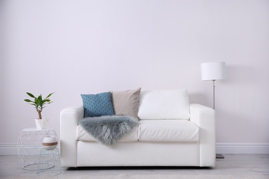 Photo of Modern living room interior with comfortable sofa. Space for text