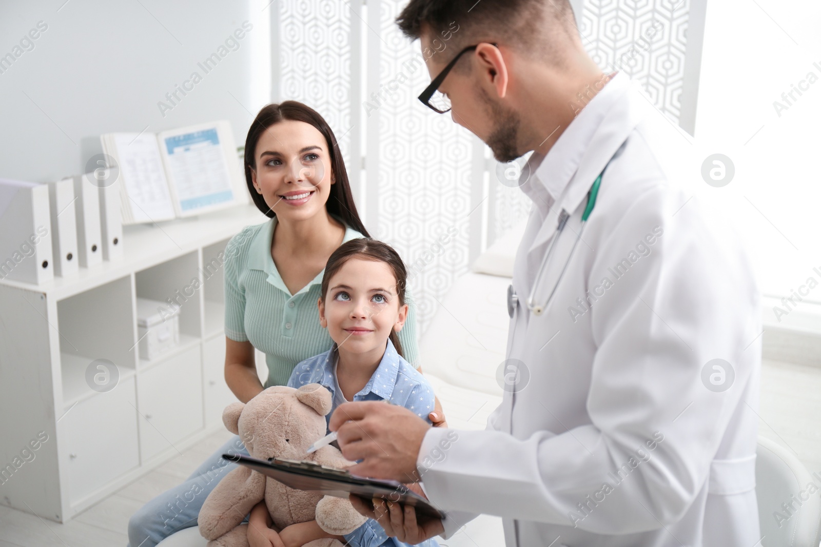 Photo of Mother with daughter visiting pediatrician in hospital